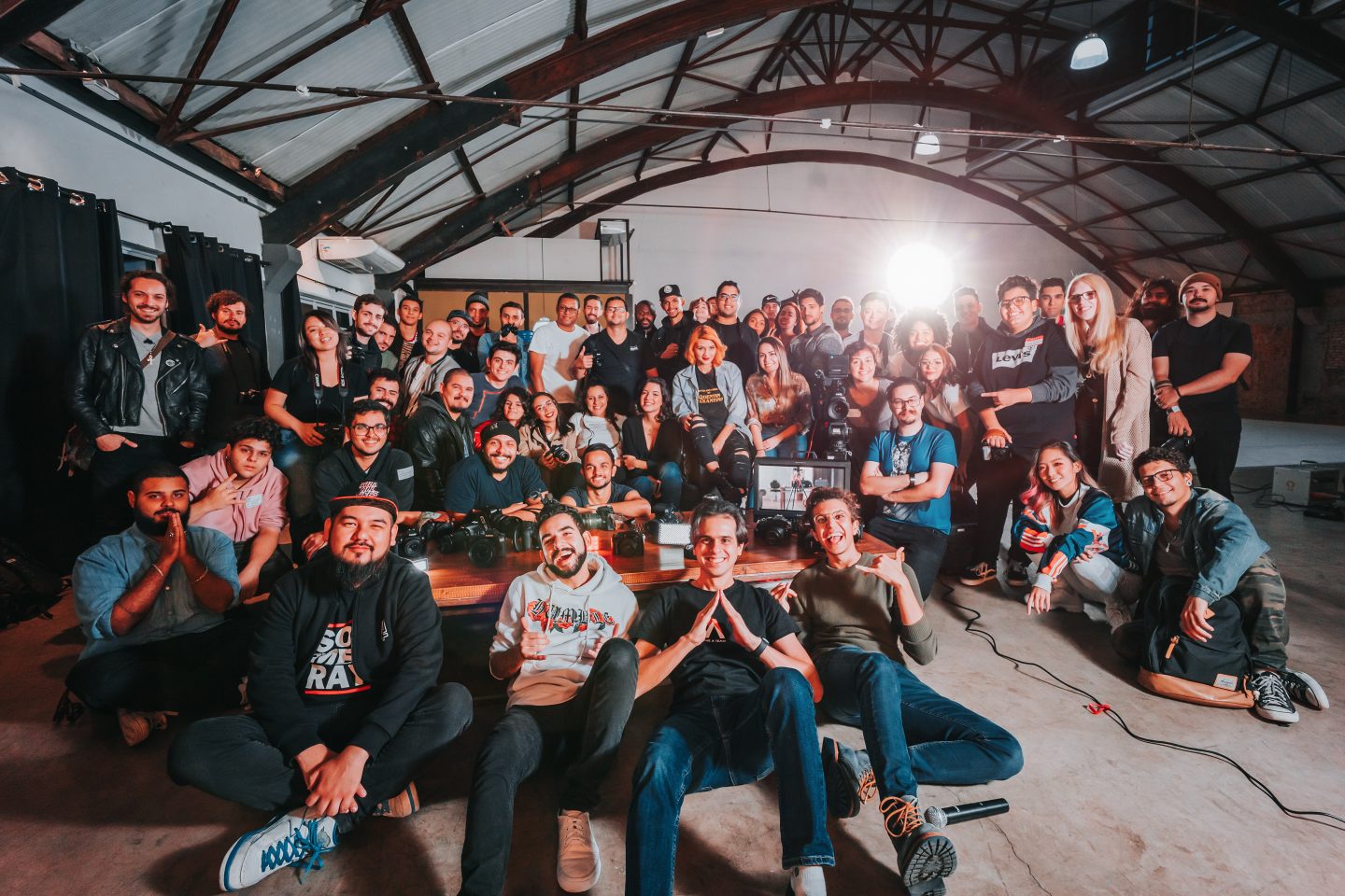 A group of industry workers posing for a photo behind the scenes on set